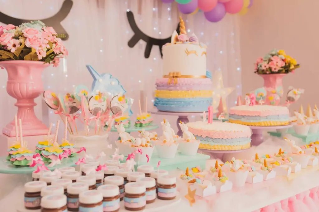 Decorated and colorful unicorn-themed cake table.